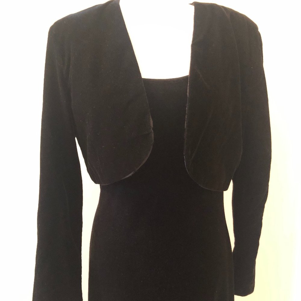 Black fitted velvet sleeveless dress with jacket.